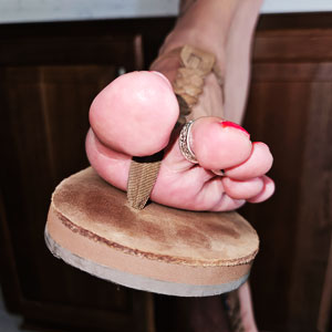 closeup of pretty toes in leather sandals